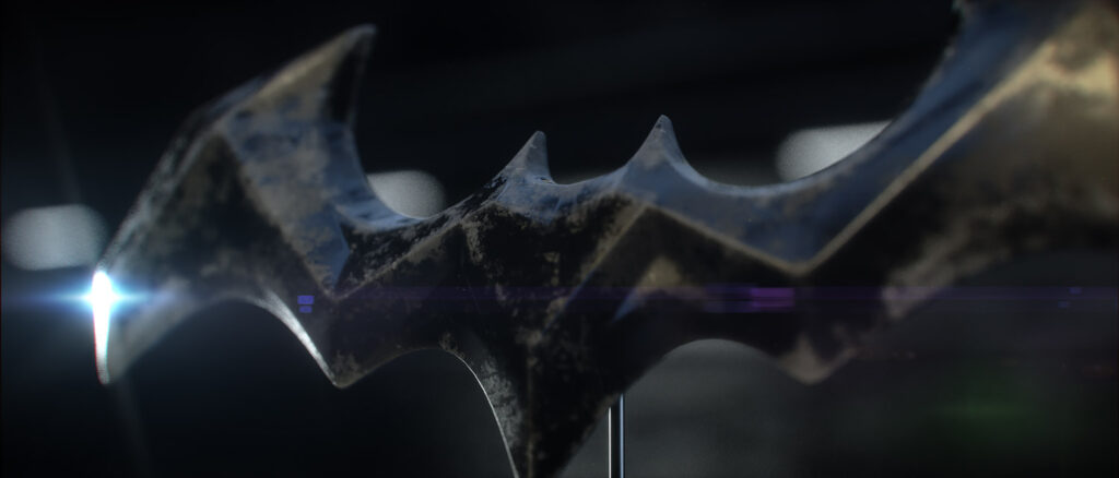 Batman Title Design Study – Composer Credit Layout An angled opening title sequence style frame displaying a placeholder composer credit layout over a technical digital interface showing the front turbine engine of a 3D Batmobile.
