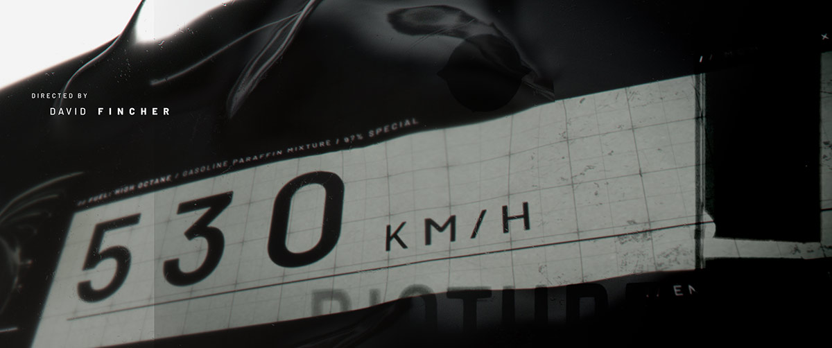 A cinematic style frame displaying a placeholder director credit layout overlaid on a white grid block with a digital speedometer reading 530 KM/H.