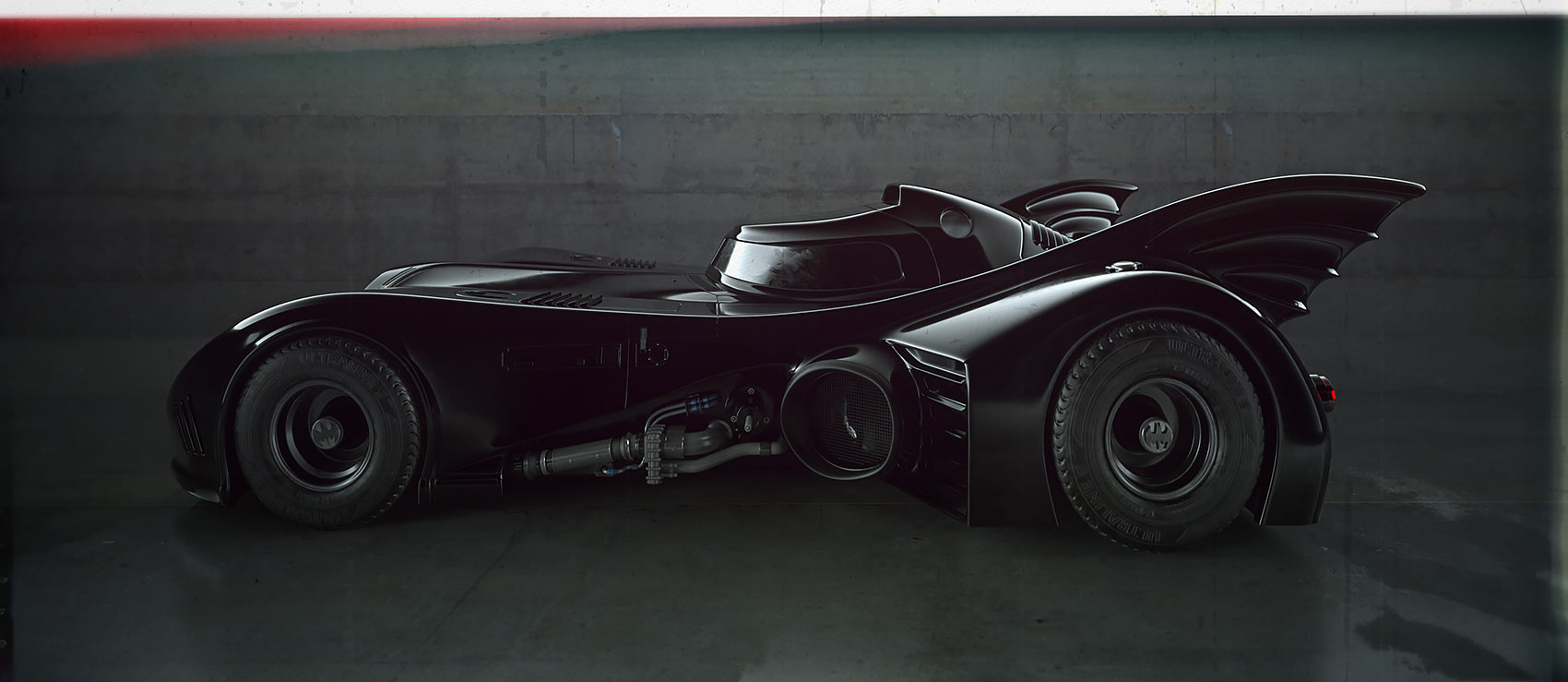 A full side profile render of the Tim Burton Batmobile model parked in a polished concrete studio environment, showcasing the sleek aerodynamic canopy, scalloped rear fins, and exposed engine bay piping.