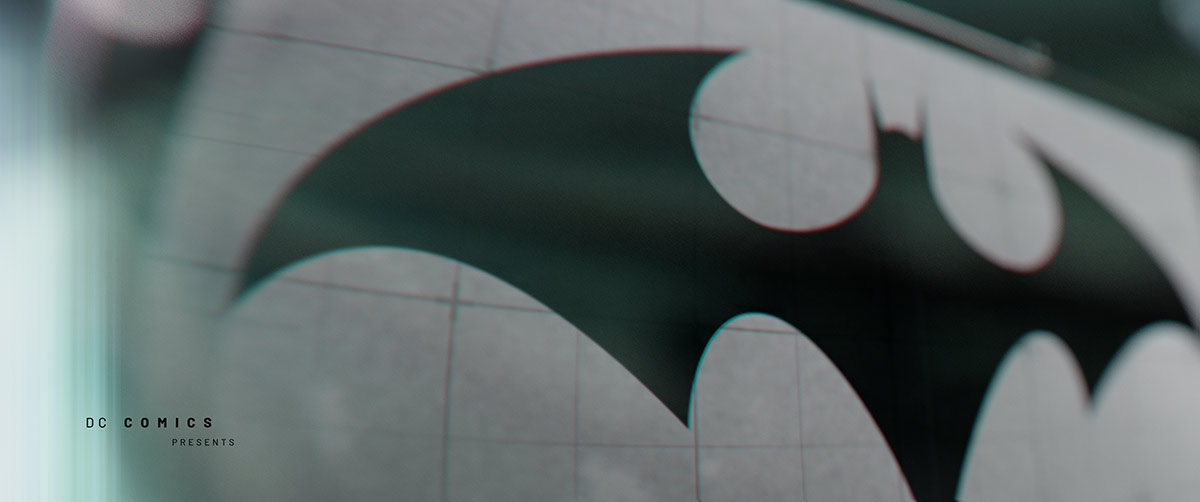 An opening title sequence style frame featuring a large, dark redesigned bat logo on a grid pattern background with the text 'DC Comics Presents' in a clean, minimalist layout.