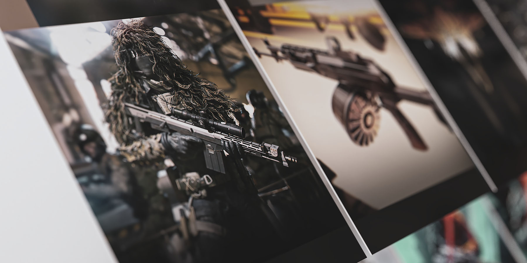 A close-up portfolio presentation view showcasing a 3D specialist character in a dense ghillie suit holding a sniper rifle, angled dramatically across a dark layout plane with clean background defocus.