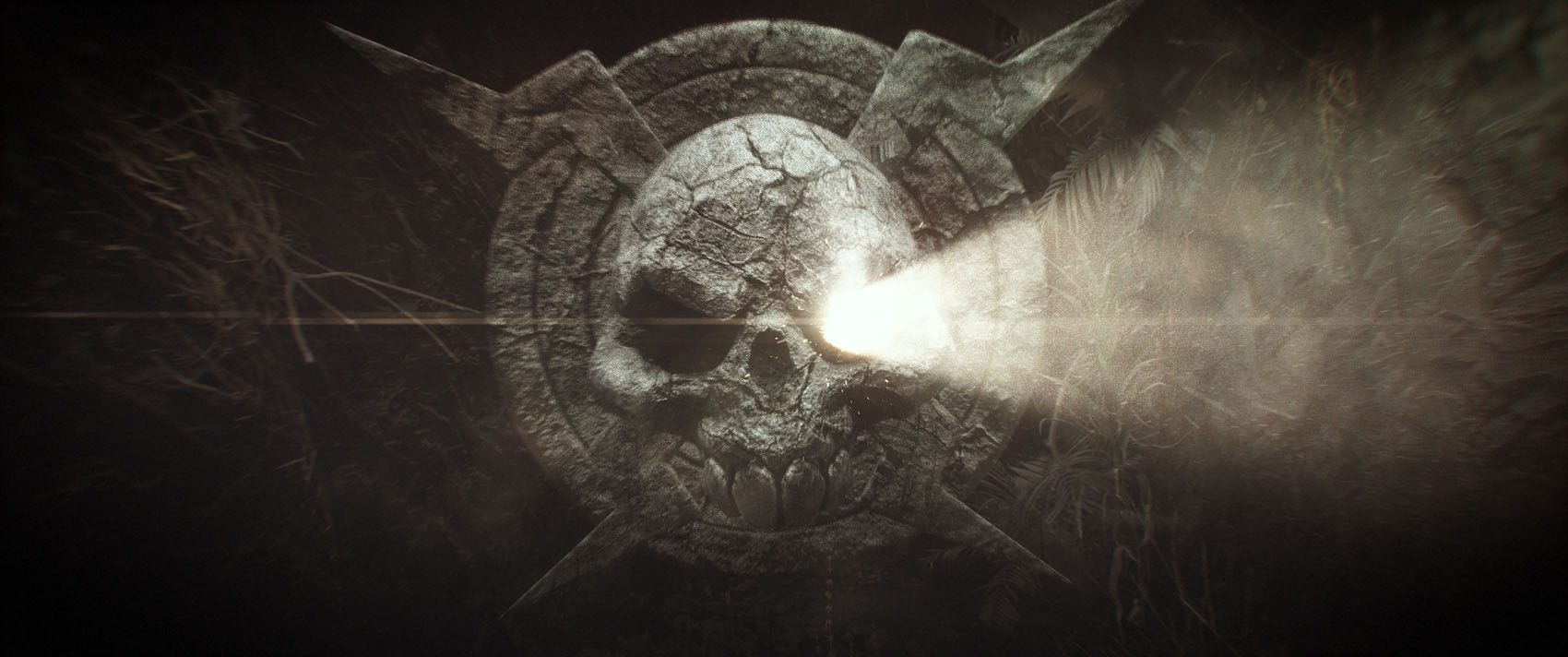 A close-up production frame capturing the intensifying golden light ray and lens flare expanding from the eye of the stone skull medallion.