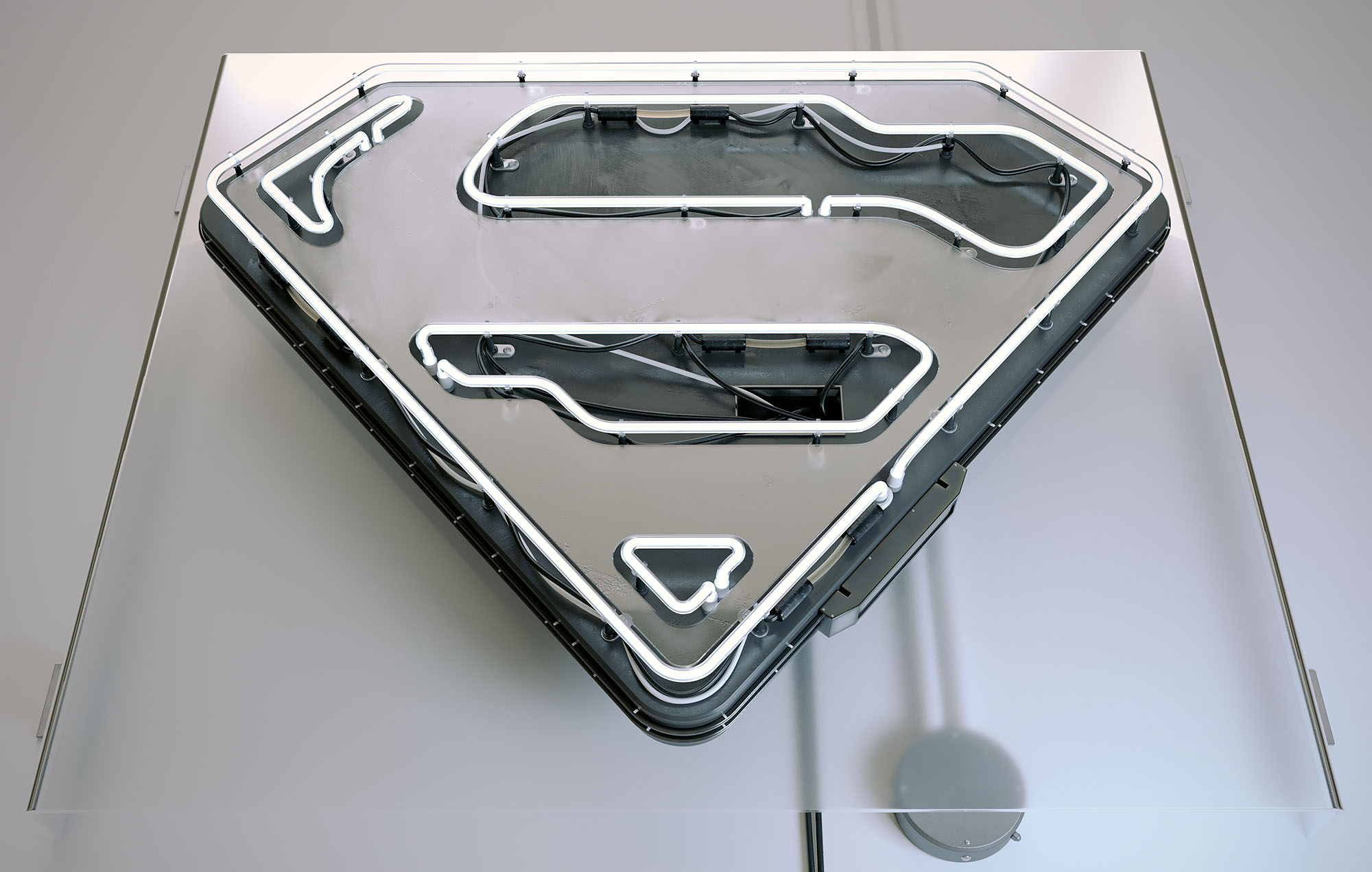 A 3D render of a contemporary Superman shield emblem designed as a realistic neon sign, featuring curved glass neon tubes, internal wiring, and a metallic backing plate, displayed on a dark portfolio website layout.