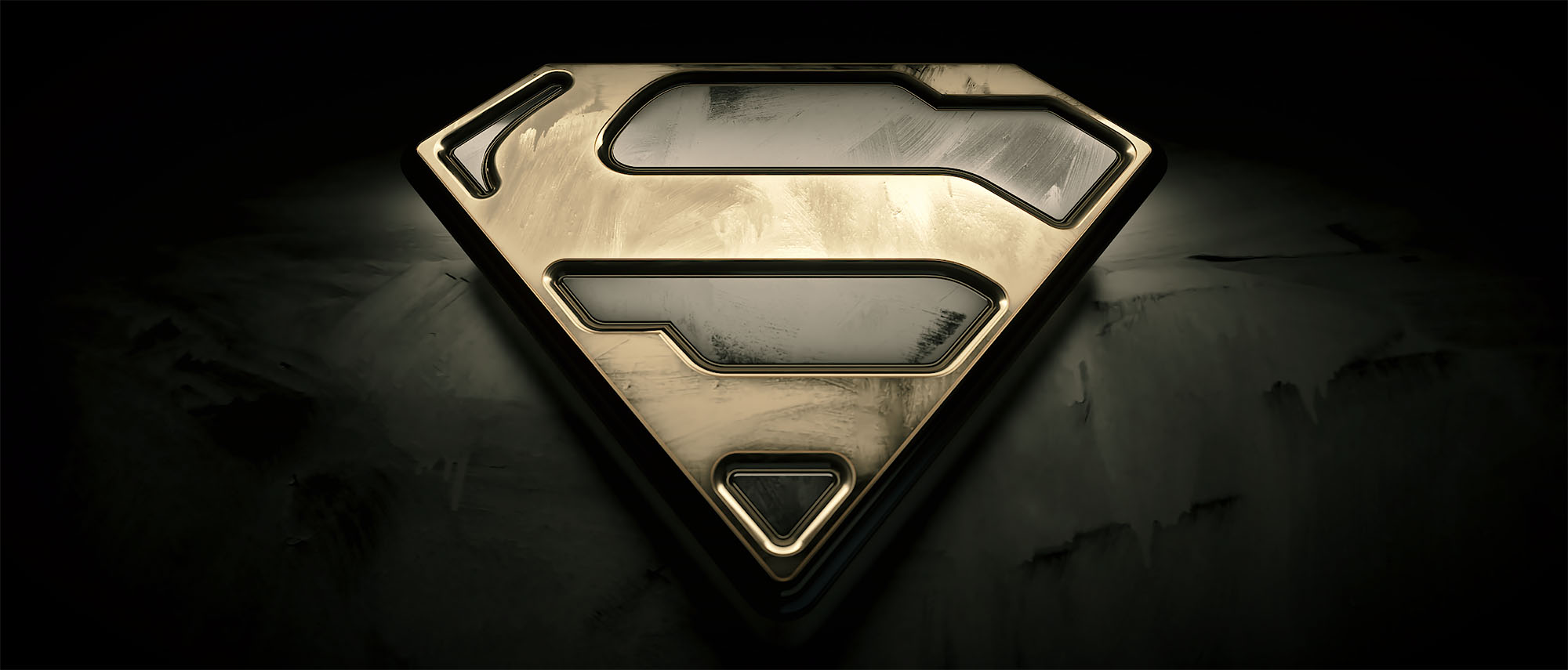 A high-contrast 3D material study of the Superman shield emblem featuring a brushed gold texture and weathered metallic bevels, positioned on a dark, rocky surface.