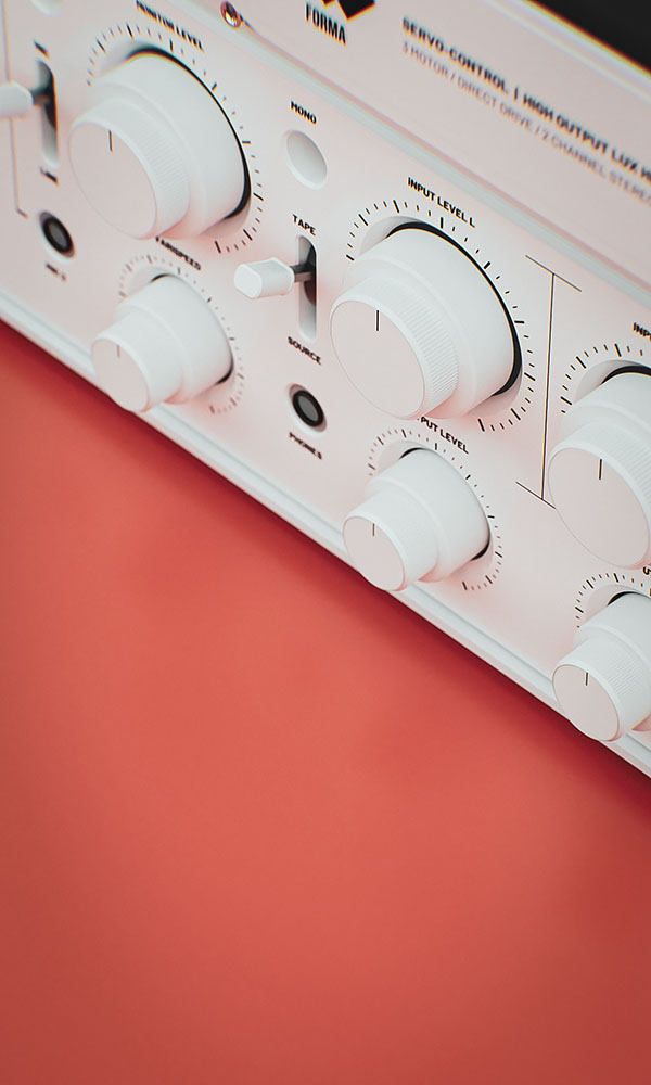 Angled close-up view of the minimalist white matte control console highlighting custom audio level adjustment knobs and toggle switches.