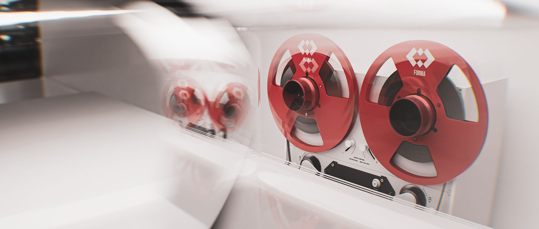 Experimental widescreen studio composition showing the red metal tape reels through a heavily blurred transparent surface for an abstract photographic look.
